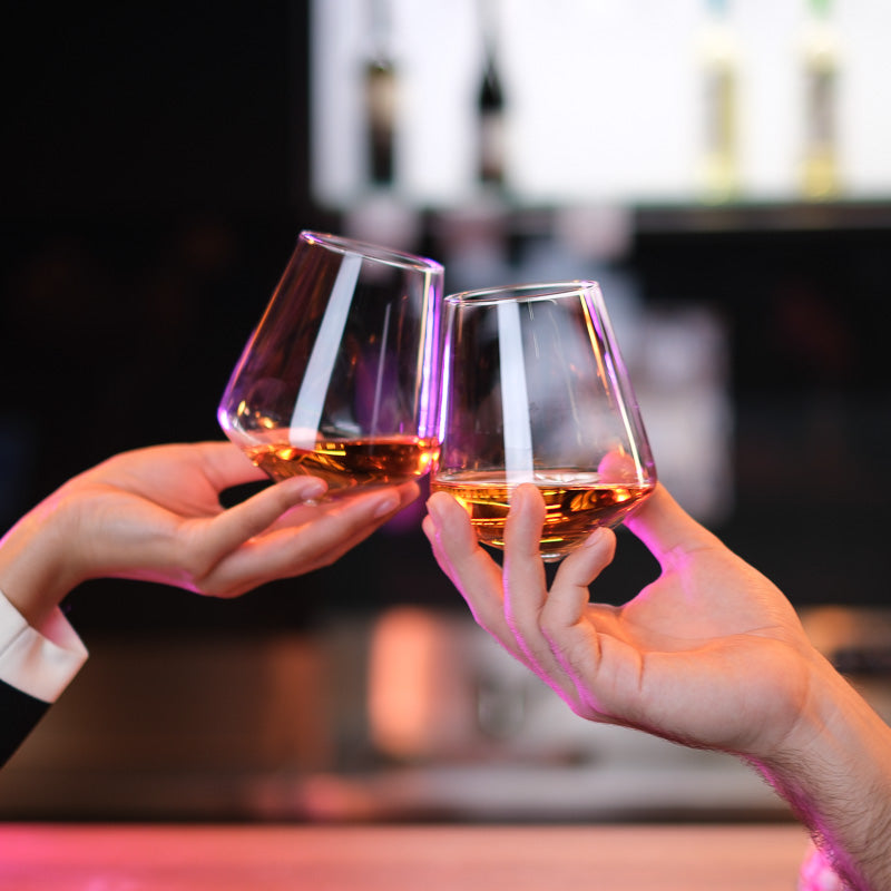 Elegant toast with handcrafted crystal glasses by Audacem, filled with whisky.