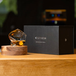 Elegant handblown Aequilibrium distillate glass by Audacem on coaster with gift box. Rotating design