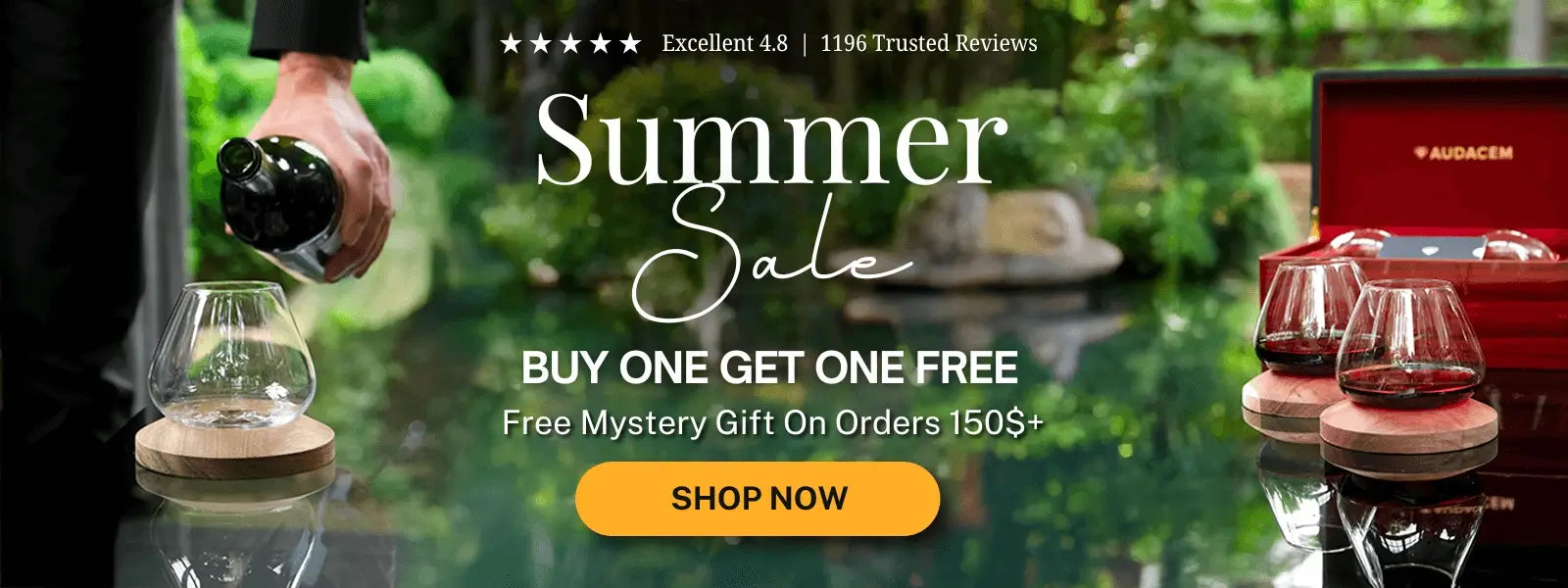 Summer sale advertisement with wine glasses and a bottle, set against a blurred outdoor background.